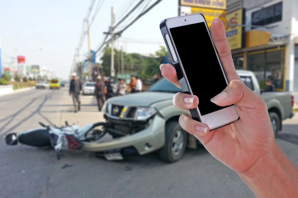 A car accident scene with two cars and a person looking scared