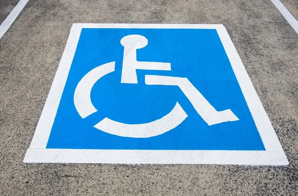 A parking placard with a disability symbol