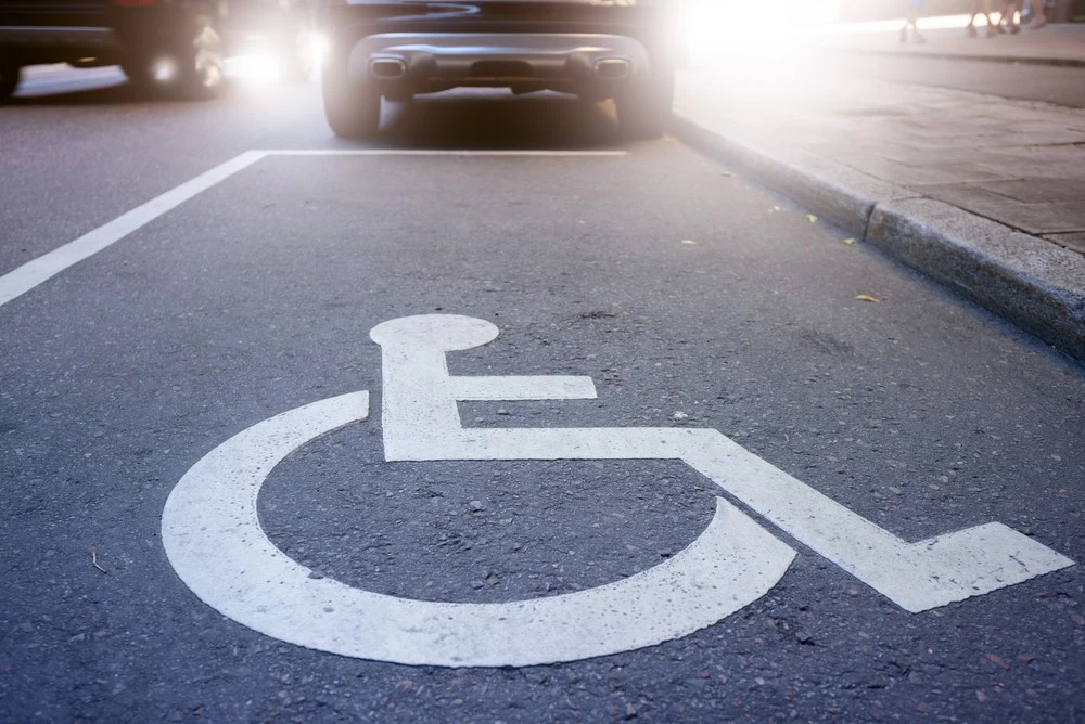 A handicapped parking space with a disabled parking placard displayed