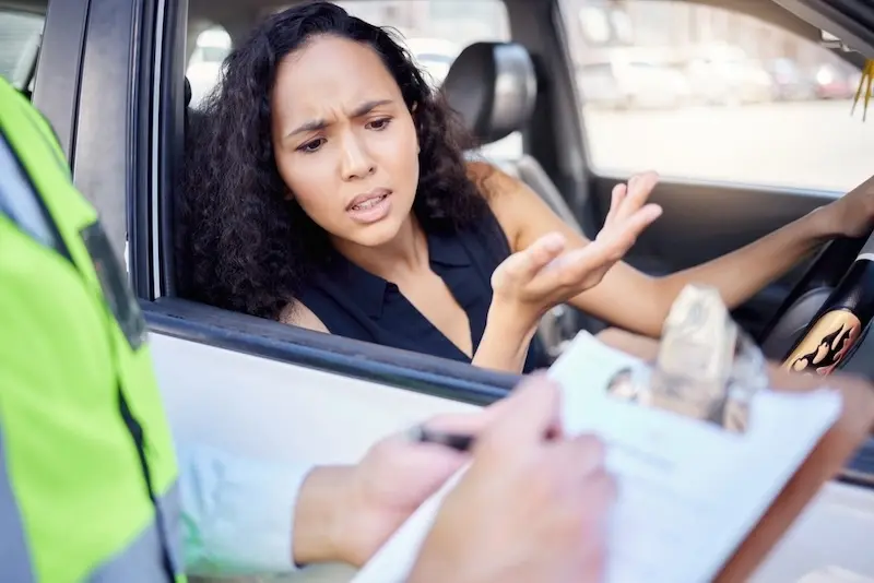 A police officer checking a driver's license with points on it